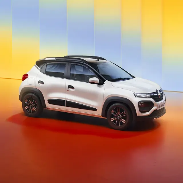 White compact SUV/crossover parked in a bright studio with vertical gradient yellow and blue panels in the background, seen from the side.