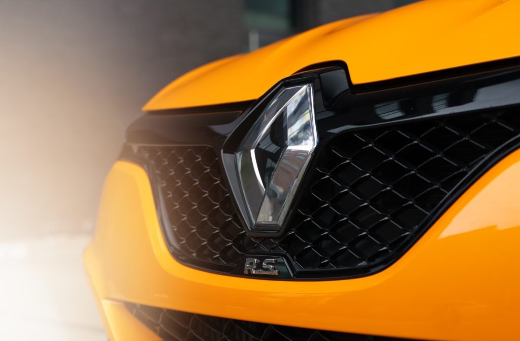 Close up of an orange renault hatchback showcasing the car manufacturing excellence