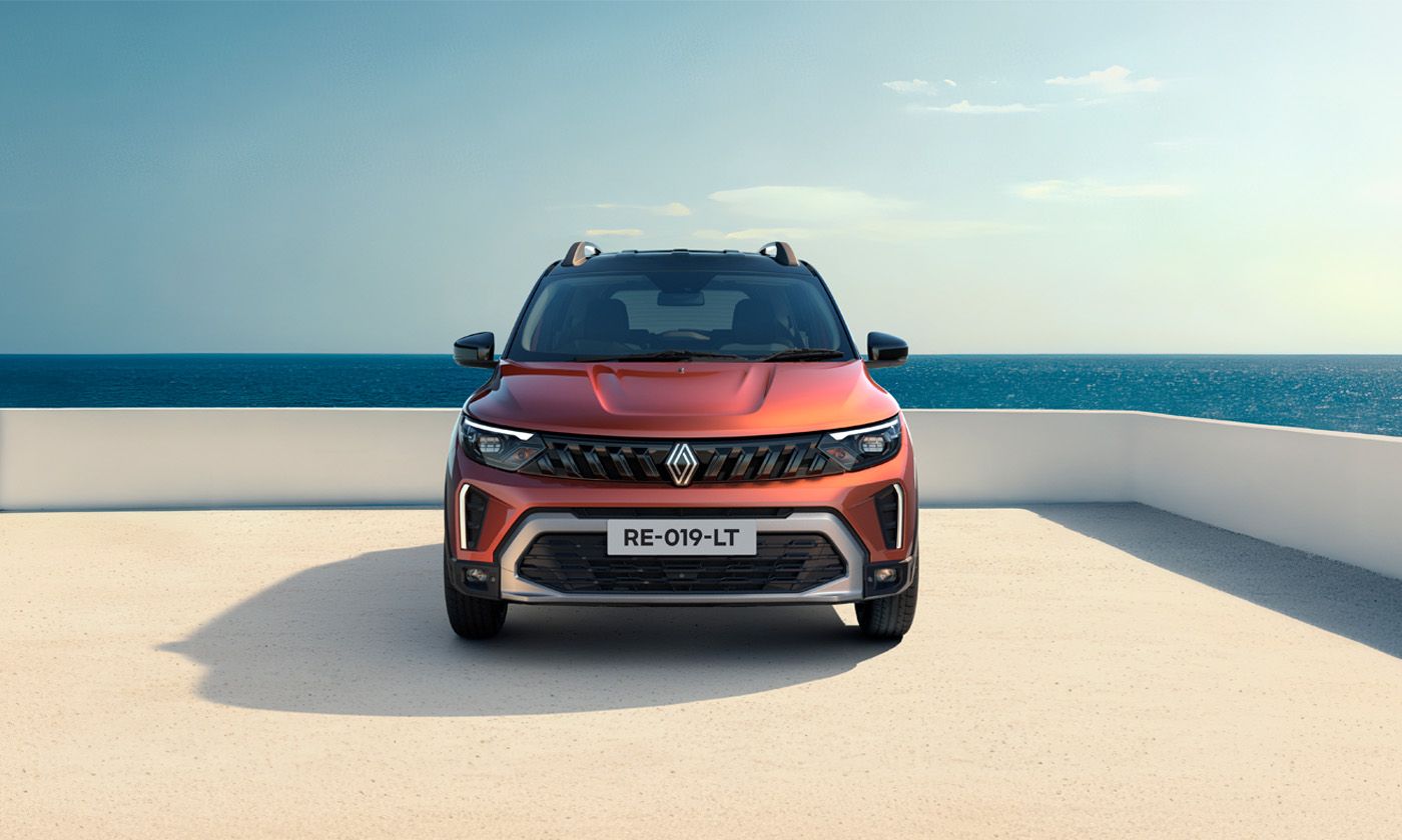 Front view of a red SUV parked on a sandy terrace overlooking the sea.