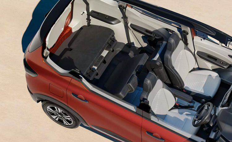 Top-down view of a red compact car with the roof retracted, showing the front seats, steering wheel, and rear seating area.]","Interior of a red convertible shown from above, with light gray seats and steering wheel visible.]","Red car with open top, interior layout visible: two front seats, center console, and rear seats folded for cargo.]","Overhead view of a red car's interior, highlighting the front passenger and driver seats and dashboard.]","Car interior exposed from above: red exterior, gray seats, steering wheel, and seating arrangement.]
