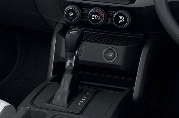 Close-up of a car center console: automatic gear lever with P R N D indicator, climate controls, and Start/Stop button.
