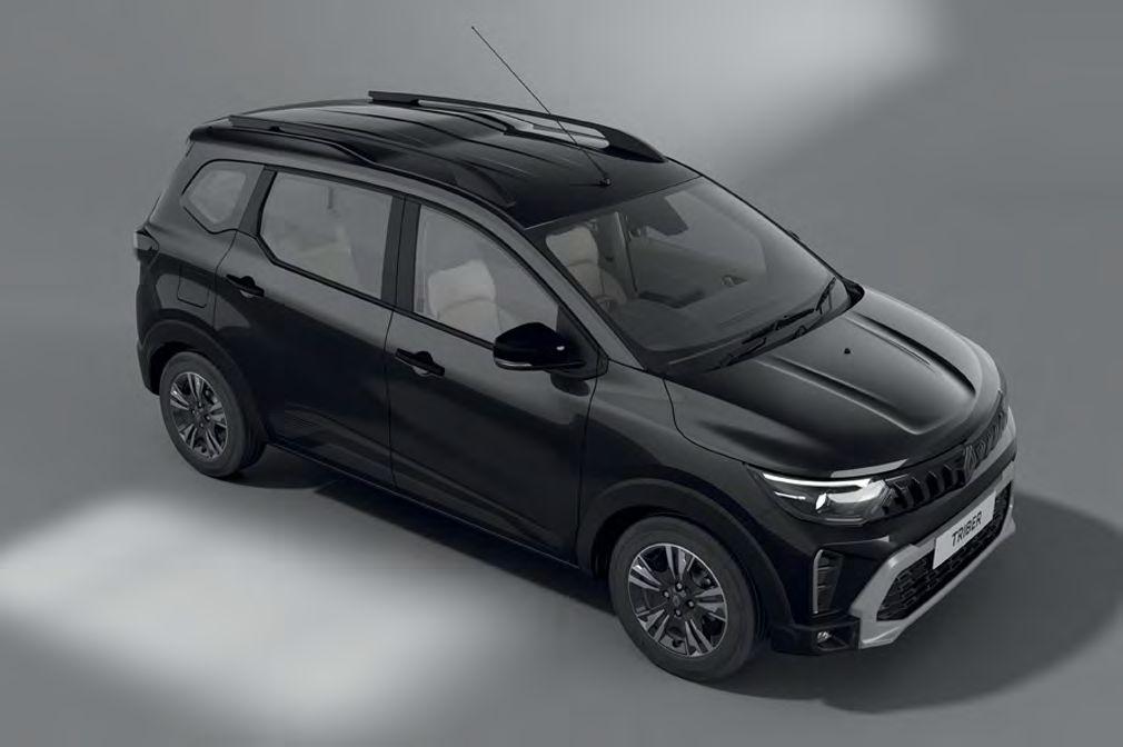 Black compact SUV viewed from a high angle in a studio, showing the front grille and roof rails.