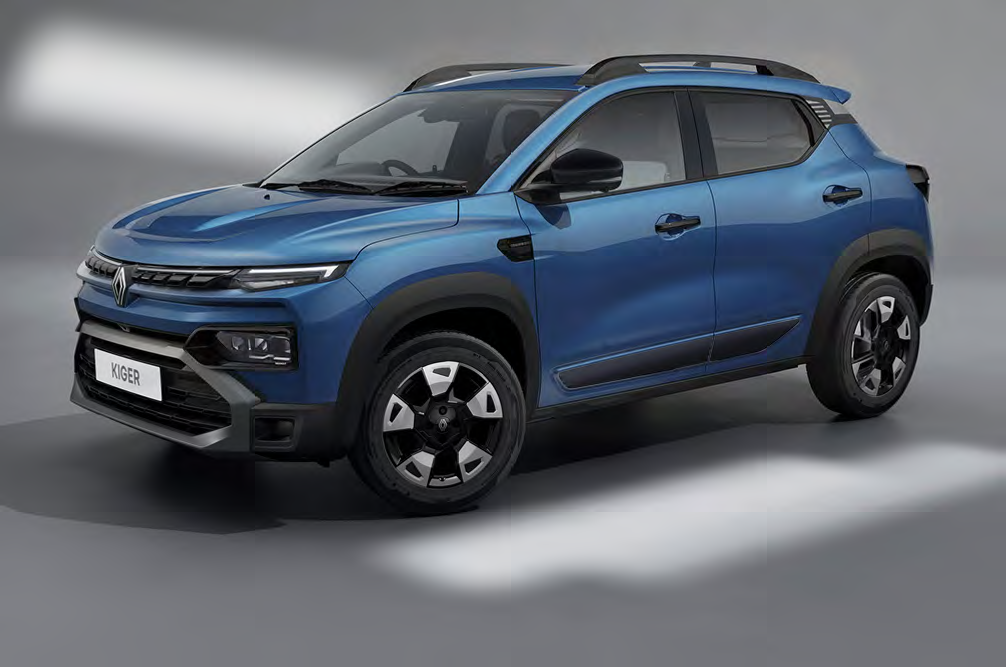 Blue Renault Kiger SUV photographed in a studio, showing a front-left three-quarter view with roof rails and dark cladding on the wheels/bumper.