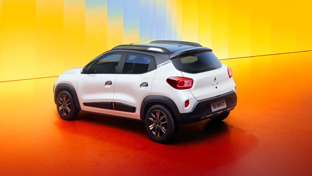 White Renault Climber SUV parked on an orange studio floor with a bright yellow gradient background