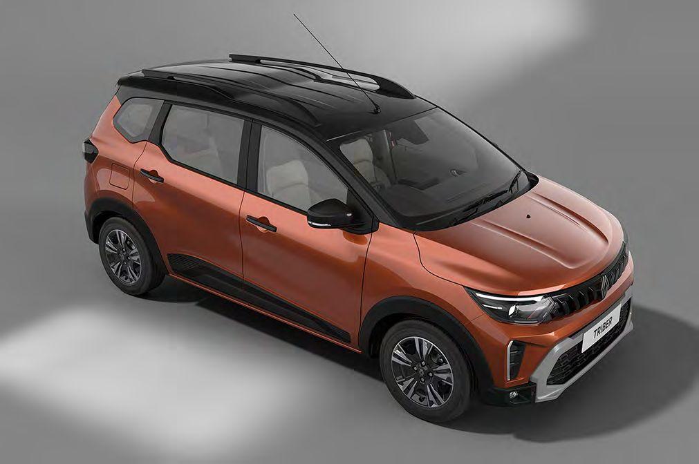 Top-front view of an orange Renault Triber compact MPV with black roof and rails, on a gray background.