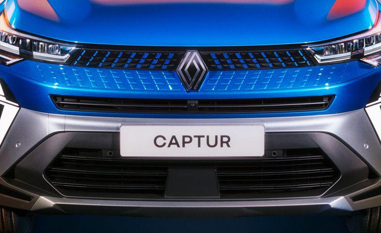 Front view of a blue Renault Captur, showing the grille, headlights, and a CAPTUR license plate.
