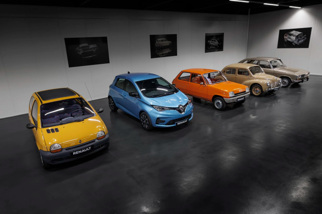 Showroom with a lineup of colorful Renault cars from yellow to beige along a wall with framed car photos above.